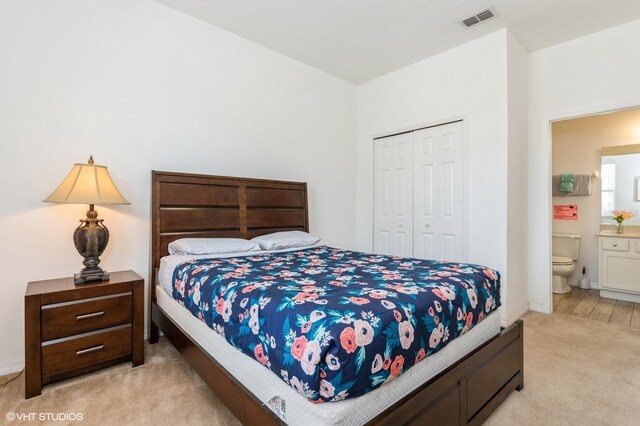 7017 Oakwood St, Davenport, FL 33837 - bedroom featuring light carpet, a closet, and connected bathroom