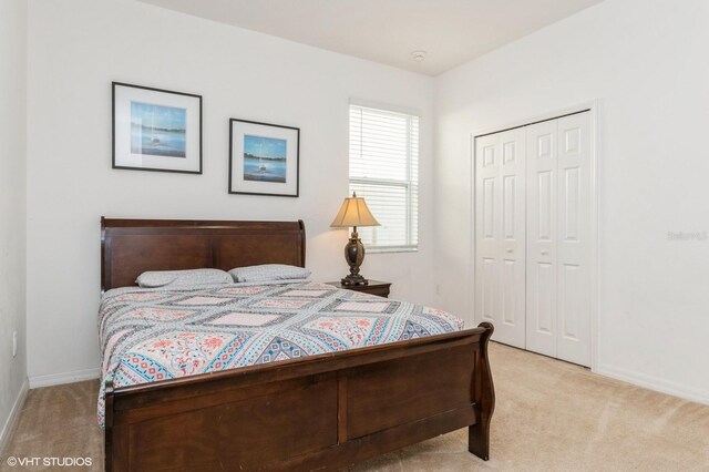 7017 Oakwood St, Davenport, FL 33837 - bedroom featuring light colored carpet, a closet, and baseboards
