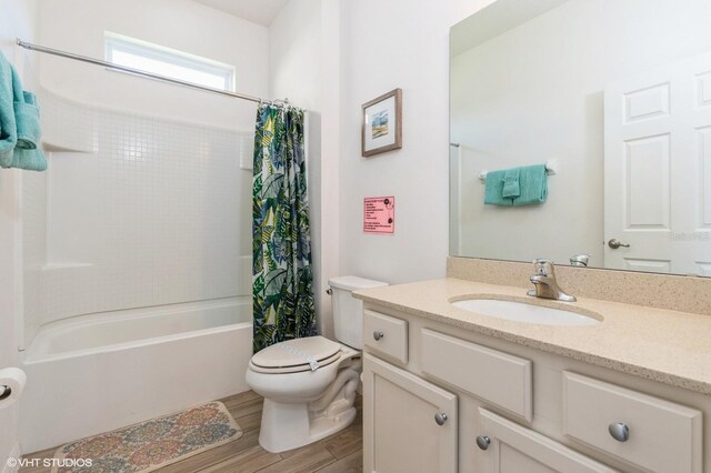 7017 Oakwood St, Davenport, FL 33837 - full bathroom with vanity, shower / bath combo with shower curtain, wood finished floors, and toilet
