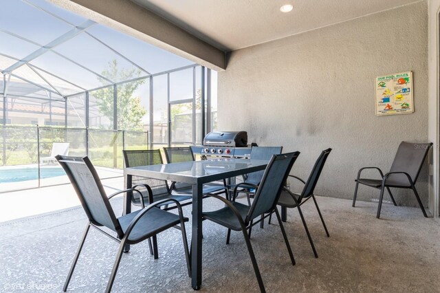 7017 Oakwood St, Davenport, FL 33837 - view of patio featuring a lanai, area for grilling, outdoor dining area, and an outdoor pool