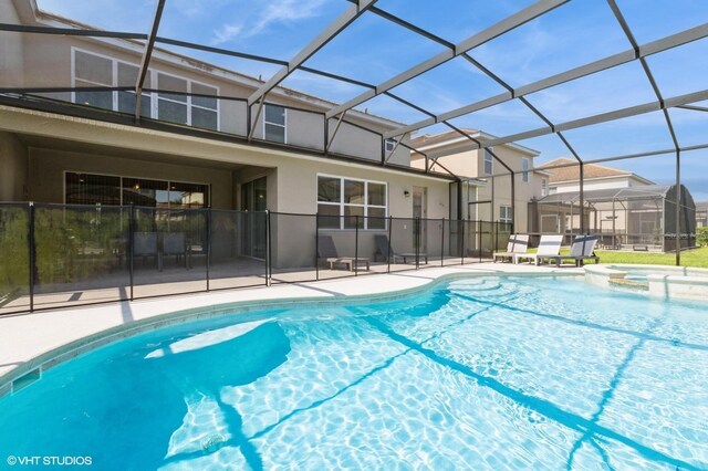 7017 Oakwood St, Davenport, FL 33837 - view of pool with a pool with connected hot tub, a patio area, and a lanai