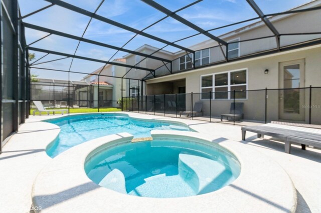 7017 Oakwood St, Davenport, FL 33837 - view of pool with a patio area, a pool with connected hot tub, and a lanai