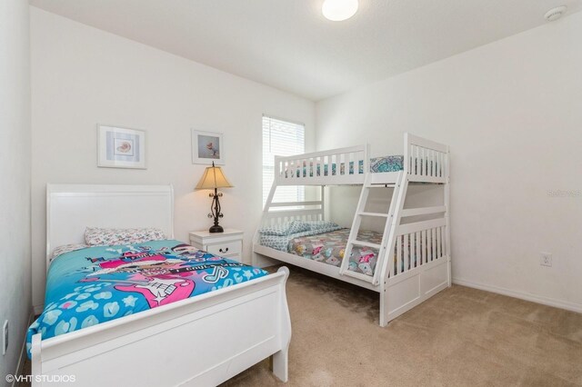 7017 Oakwood St, Davenport, FL 33837 - carpeted bedroom with baseboards