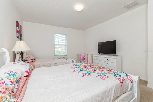 7017 Oakwood St, Davenport, FL 33837 - bedroom featuring light carpet and baseboards