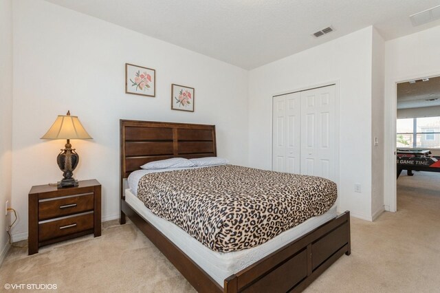 7017 Oakwood St, Davenport, FL 33837 - bedroom featuring light colored carpet, a closet, and baseboards