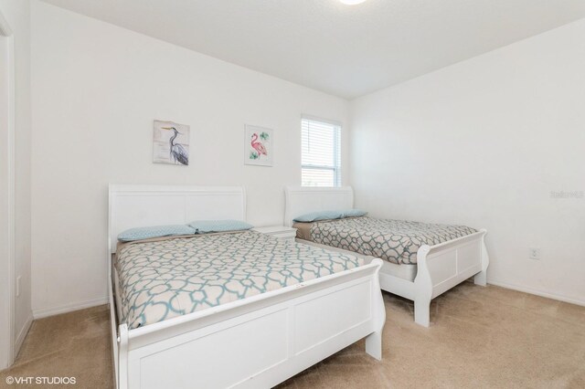 7017 Oakwood St, Davenport, FL 33837 - bedroom with light carpet and baseboards