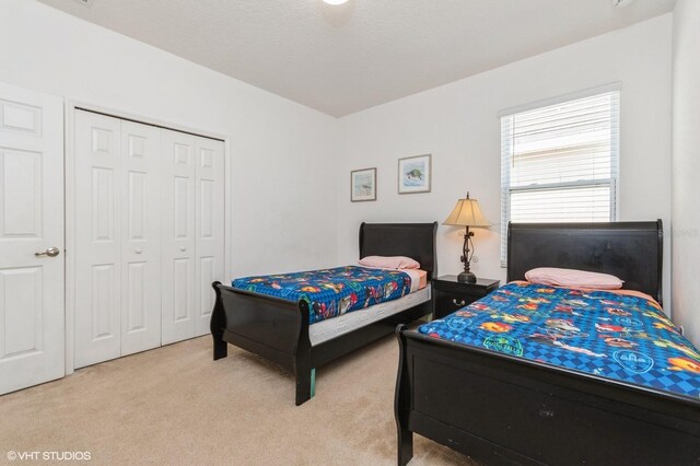 7017 Oakwood St, Davenport, FL 33837 - bedroom featuring light carpet and a closet