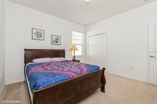 7017 Oakwood St, Davenport, FL 33837 - carpeted bedroom featuring a closet and baseboards