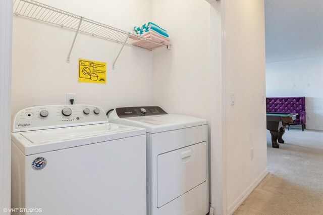 7017 Oakwood St, Davenport, FL 33837 - laundry area with light colored carpet, washing machine and dryer, and baseboards