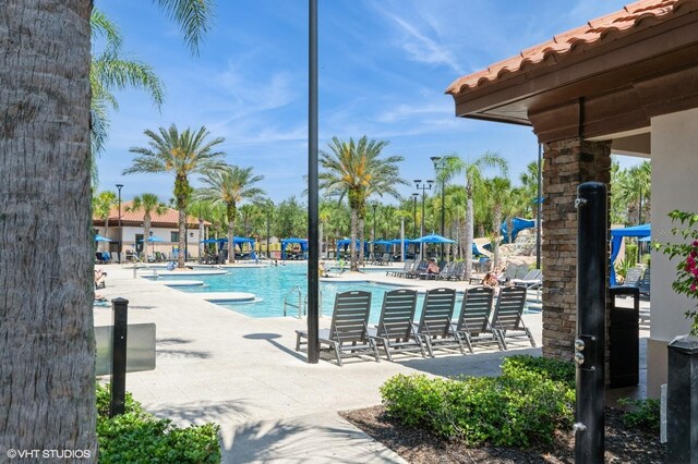 7017 Oakwood St, Davenport, FL 33837 - community pool with a patio area