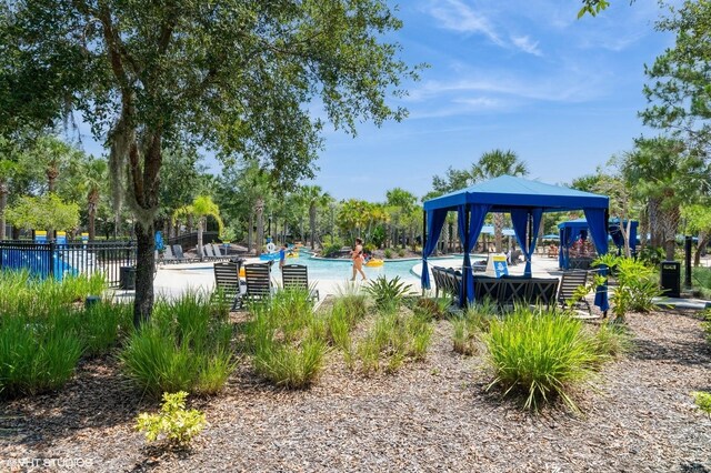 7017 Oakwood St, Davenport, FL 33837 - view of community featuring a pool and a gazebo
