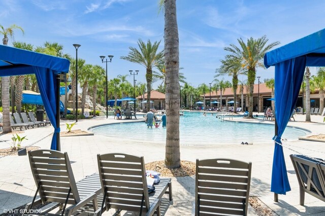 7017 Oakwood St, Davenport, FL 33837 - community pool featuring a patio