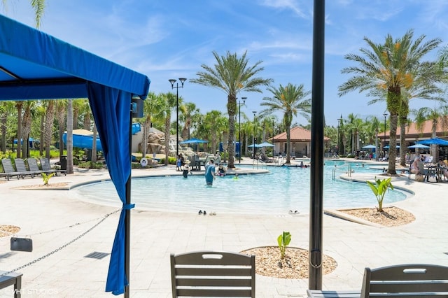7017 Oakwood St, Davenport, FL 33837 - community pool featuring a patio area