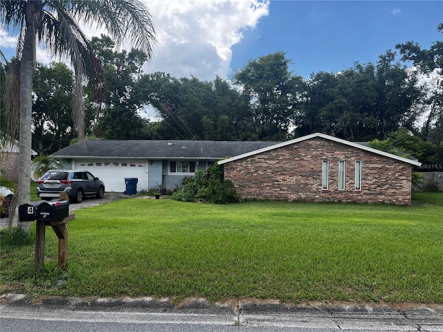 5 Riverdale Ave, Ormond Beach, FL 32174 - ranch-style house featuring a garage, a front lawn, and brick siding