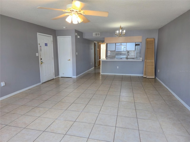 3157 Britannia Blvd Unit B, Kissimmee, FL 34747 - unfurnished living room featuring a sink, a ceiling fan, a chandelier, baseboards, and a textured ceiling