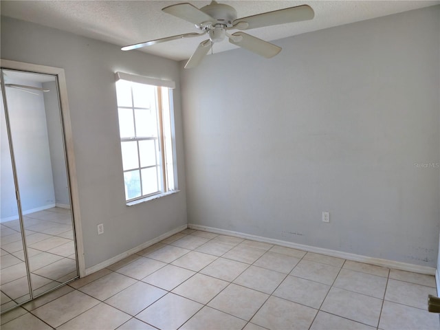 3157 Britannia Blvd Unit B, Kissimmee, FL 34747 - unfurnished room featuring light tile patterned floors, ceiling fan, a textured ceiling, and baseboards