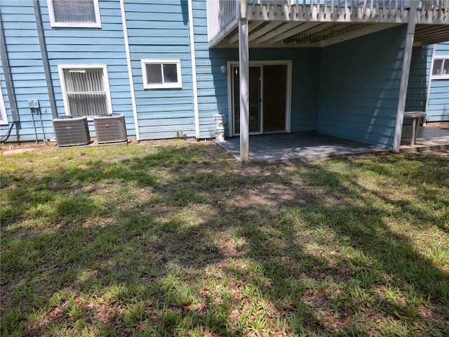 3157 Britannia Blvd Unit B, Kissimmee, FL 34747 - back of house featuring central air condition unit, a patio area, and a yard