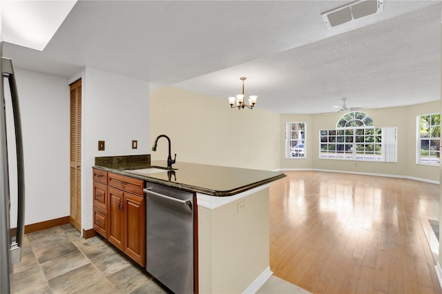 2020 Royal Bay Blvd Unit 91, Kissimmee, FL 34746 - kitchen featuring stainless steel dishwasher, a sink, baseboards, brown cabinets, and a chandelier