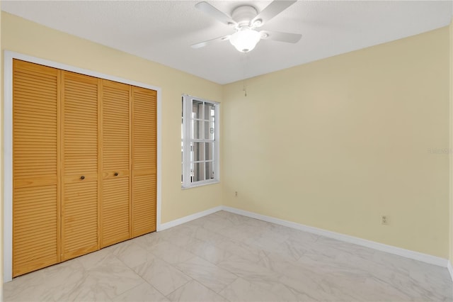 2020 Royal Bay Blvd Unit 91, Kissimmee, FL 34746 - unfurnished bedroom with light marble finish floors, a closet, baseboards, and a ceiling fan