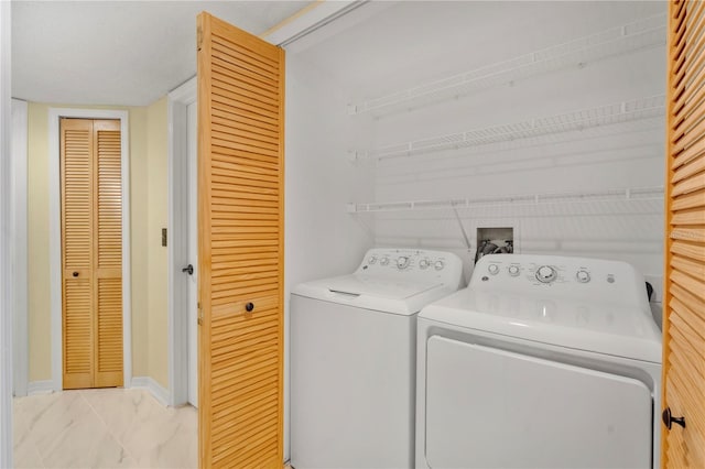 2020 Royal Bay Blvd Unit 91, Kissimmee, FL 34746 - washroom with light marble finish flooring, independent washer and dryer, and baseboards