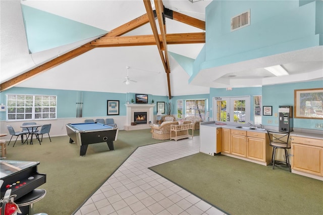 2020 Royal Bay Blvd Unit 91, Kissimmee, FL 34746 - game room featuring light carpet, high vaulted ceiling, a sink, a lit fireplace, and beam ceiling