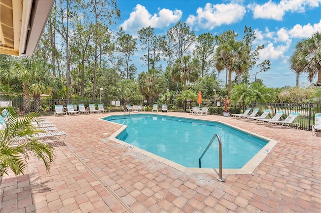 2020 Royal Bay Blvd Unit 91, Kissimmee, FL 34746 - community pool featuring a patio area and view of wooded area