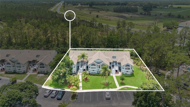 2020 Royal Bay Blvd Unit 91, Kissimmee, FL 34746 - aerial view of property and surrounding area with property parcel outlined and a heavily wooded area