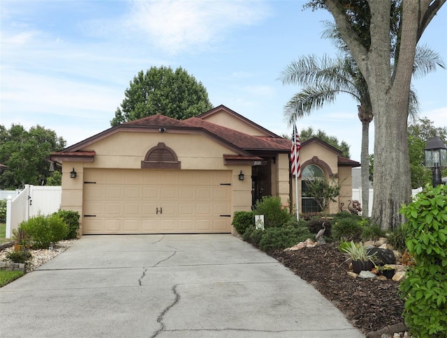 2021 Wildfire Ct, Apopka, FL 32703 - ranch-style house with driveway, stucco siding, and a garage