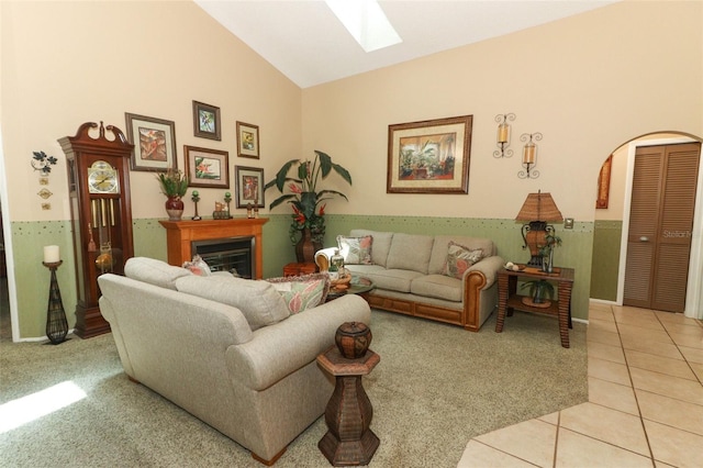 2021 Wildfire Ct, Apopka, FL 32703 - living area with a skylight, light colored carpet, light tile patterned floors, high vaulted ceiling, and a fireplace