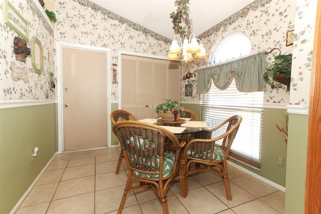 2021 Wildfire Ct, Apopka, FL 32703 - dining space with wallpapered walls, a chandelier, vaulted ceiling, tile patterned floors, and healthy amount of natural light