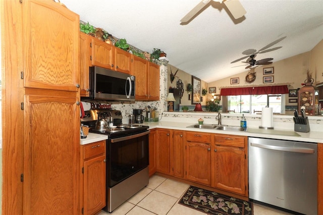 2021 Wildfire Ct, Apopka, FL 32703 - kitchen featuring stainless steel appliances, a sink, ceiling fan, lofted ceiling, and light countertops
