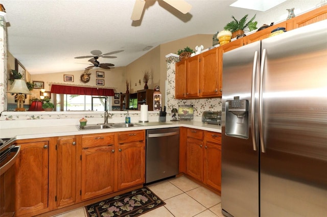 2021 Wildfire Ct, Apopka, FL 32703 - kitchen featuring appliances with stainless steel finishes, a sink, a ceiling fan, light countertops, and vaulted ceiling