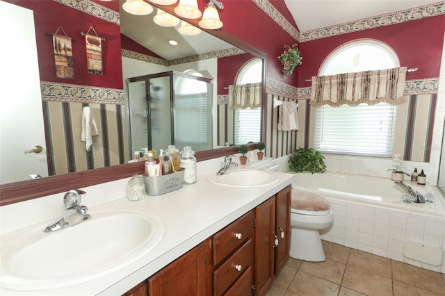 2021 Wildfire Ct, Apopka, FL 32703 - full bathroom featuring lofted ceiling, a shower stall, a garden tub, tile patterned flooring, and toilet