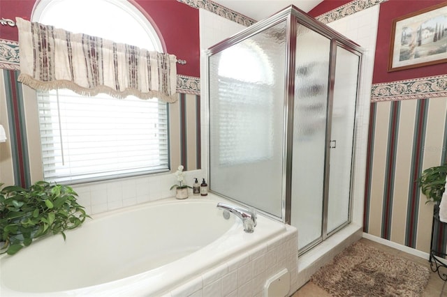 2021 Wildfire Ct, Apopka, FL 32703 - bathroom with a stall shower, wallpapered walls, and a bath