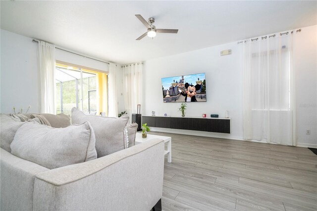 17614 Woodcrest Way, Clermont, FL 34714 - living area with a ceiling fan and light wood finished floors