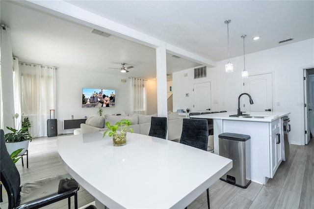 17614 Woodcrest Way, Clermont, FL 34714 - kitchen with a sink, ceiling fan, a center island with sink, white cabinetry, and recessed lighting