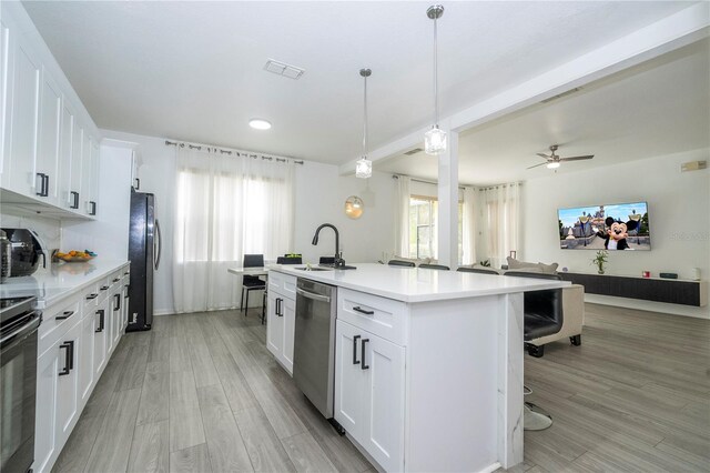17614 Woodcrest Way, Clermont, FL 34714 - kitchen with a sink, dishwasher, freestanding refrigerator, open floor plan, and an island with sink