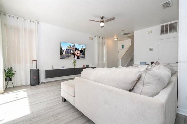17614 Woodcrest Way, Clermont, FL 34714 - living room featuring stairs, wood finished floors, and ceiling fan