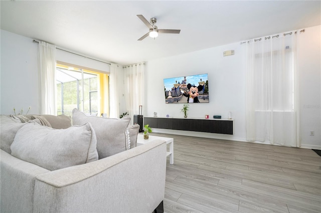 17614 Woodcrest Way, Clermont, FL 34714 - living area with a ceiling fan and light wood finished floors