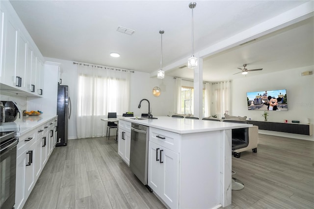17614 Woodcrest Way, Clermont, FL 34714 - kitchen with a sink, dishwasher, freestanding refrigerator, open floor plan, and an island with sink