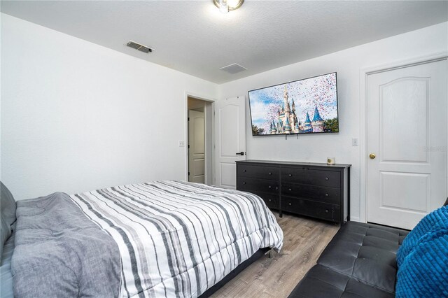 17614 Woodcrest Way, Clermont, FL 34714 - bedroom featuring wood finished floors