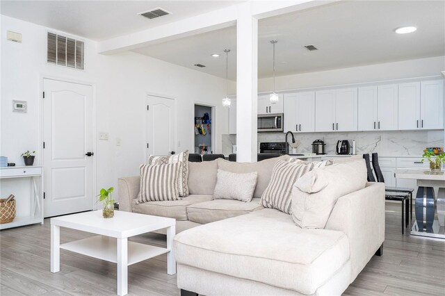 17614 Woodcrest Way, Clermont, FL 34714 - living room with light wood-type flooring and recessed lighting