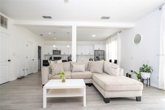 17614 Woodcrest Way, Clermont, FL 34714 - living area with recessed lighting, light wood finished floors, baseboards, and beamed ceiling