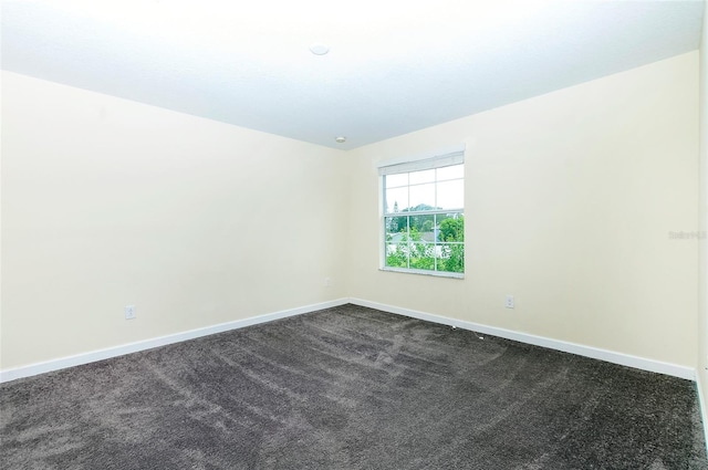 1748 Thetford Cir, Orlando, FL 32824 - empty room with baseboards and dark colored carpet