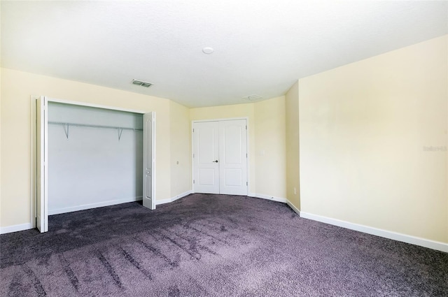 1748 Thetford Cir, Orlando, FL 32824 - unfurnished bedroom featuring dark carpet, baseboards, and a closet