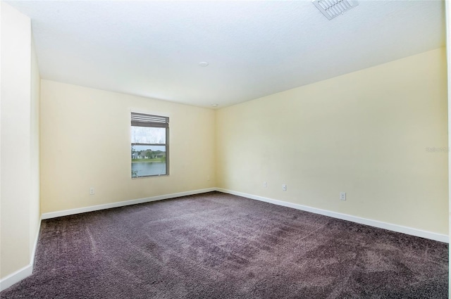 1748 Thetford Cir, Orlando, FL 32824 - spare room with dark colored carpet and baseboards