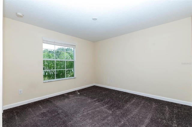 1748 Thetford Cir, Orlando, FL 32824 - unfurnished room with baseboards, dark colored carpet, and a smoke detector