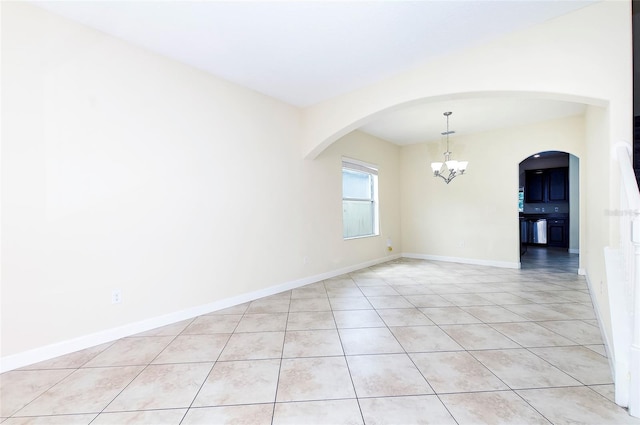 1748 Thetford Cir, Orlando, FL 32824 - unfurnished room featuring a chandelier, light tile patterned floors, arched walkways, and baseboards