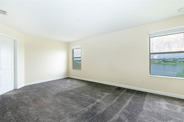 1748 Thetford Cir, Orlando, FL 32824 - unfurnished room featuring dark colored carpet and baseboards