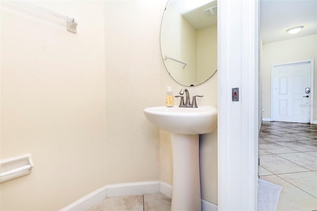 1748 Thetford Cir, Orlando, FL 32824 - bathroom featuring tile patterned floors, baseboards, and a sink